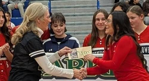 CAROL FINNEY AWARD – January 18, 2025 $13,000 IKE FAST PITCH SOFTBALL Nancy Leahy handing the check to Coach Paige West Phill Fossum photograph
