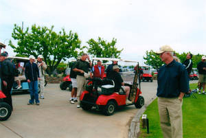 Golfers gathering around the breakfast layout before heading out for the shotgun start